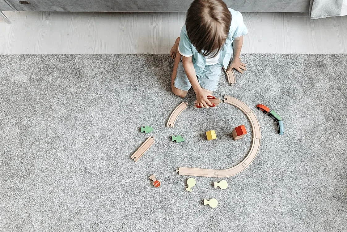 A child playing on a carpet